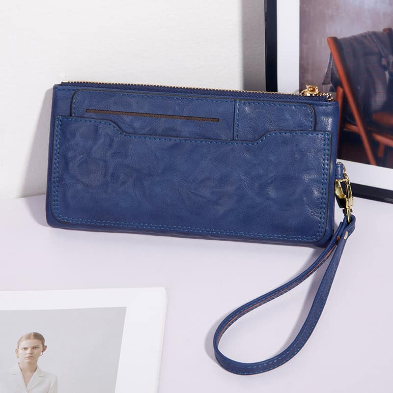 Luxurious blue leather clutch bag with wrist strap, perfect for fashion and practicality, featured on Monalisa Store's curated collection of women's accessories and handbags.