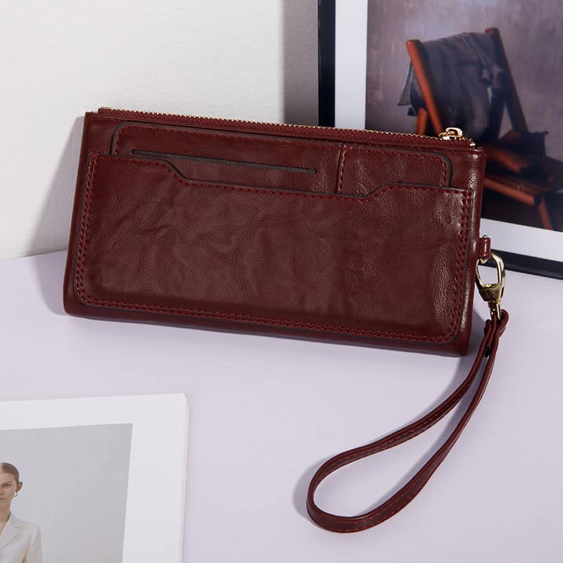 Vintage leather wallet with wrist strap, ideal for women and men, stylish accessory for travel and daily use.