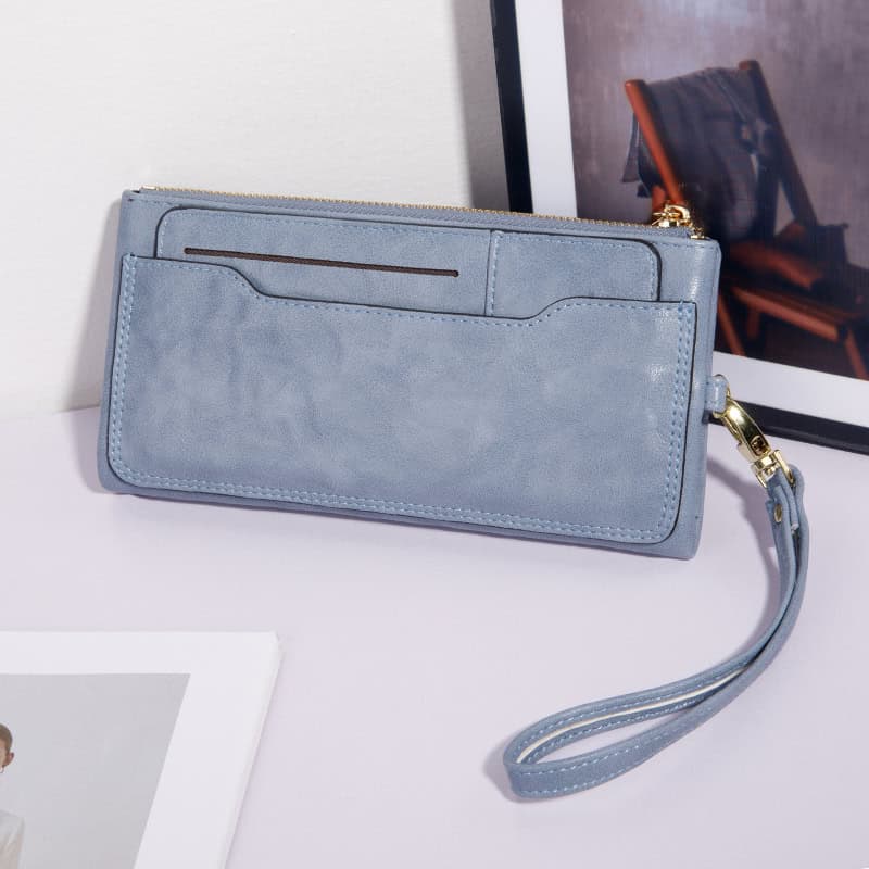 Luxury light blue leather wristlet purse with multiple card slots and zipper closure for women, stylish accessory for everyday use and evening outings.