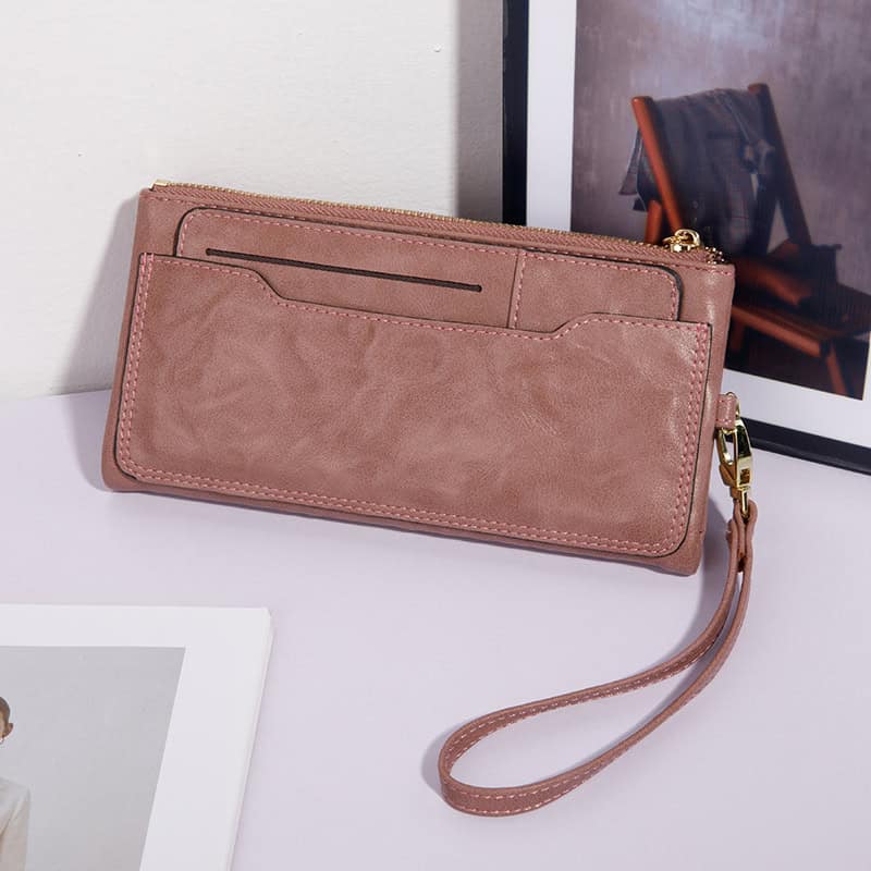 Pink leather wallet with wrist strap featuring card slots and zip closure for women’s accessories and everyday use - Monalisa Store.