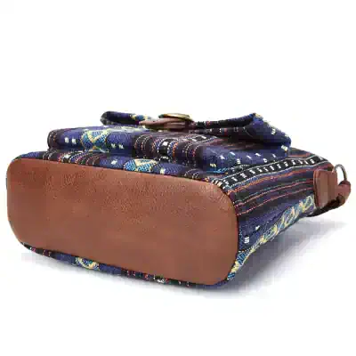 Vibrant woven fabric handbag with leather bottom, featuring intricate colorful patterns, stylish design, and secure clasp, perfect for women’s fashion and accessories.