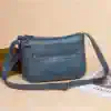 Versatile blue leather crossbody bag with multiple zippered compartments for women, perfect for everyday use and style.