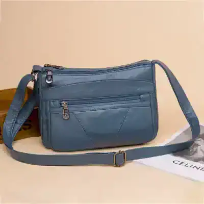 Versatile blue leather crossbody bag with multiple zippered compartments for women, perfect for everyday use and style.