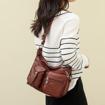 Stylish brown crossbody bag with multiple zippered compartments, perfect for daily use and travel, offering organized storage and convenience for women on the go.