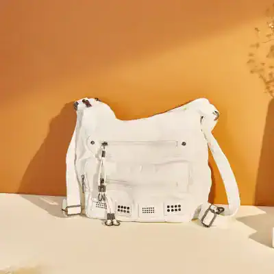 Stylish white designer shoulder bag with multiple zippered compartments, perfect for daily use and fashion accessories.