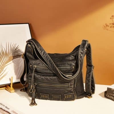 Stylish black leather handbag with multiple zippered compartments, perfect for fashionable and functional daily use. Ideal for women seeking luxury design in an elegant, versatile accessory.