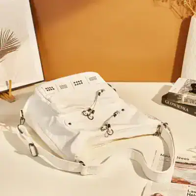 Silicone eye mask with adjustable straps, used for eye beauty treatments and relaxation, on a white table with books and decor in background.