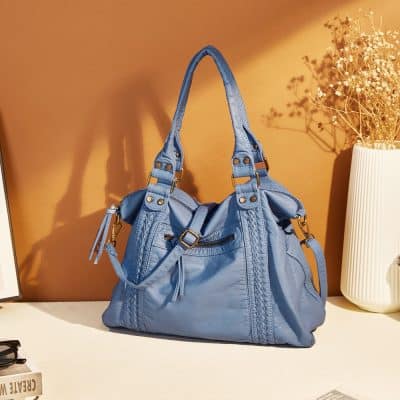 Blue leather handbag with multiple compartments and gold hardware from Monalisa Store, perfect for stylish accessories and women's fashion.