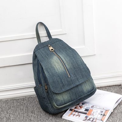 Backpack for women, stylish denim design with multiple compartments, perfect for daily use and travel.