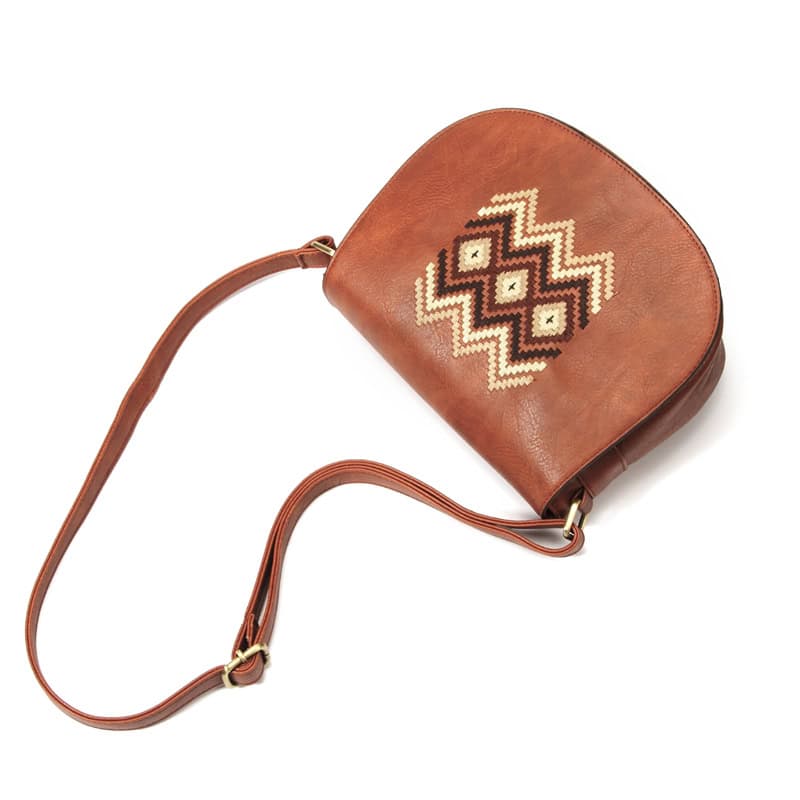 Vintage leather crossbody bag with ethnic geometric embroidery, stylish accessory for women. Perfect for casual or boho fashion, durable and lightweight.