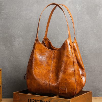 Luxurious brown leather tote bag with spacious interior, perfect for stylish everyday use and carrying essentials. Crafted from high-quality leather, ideal for fashion-forward individuals.