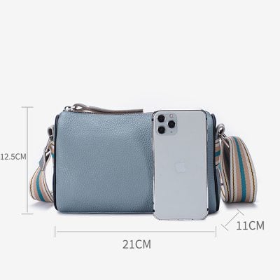Light blue leather crossbody bag with strap, smartphone, and measurement details perfect for optical accessories and daily use.