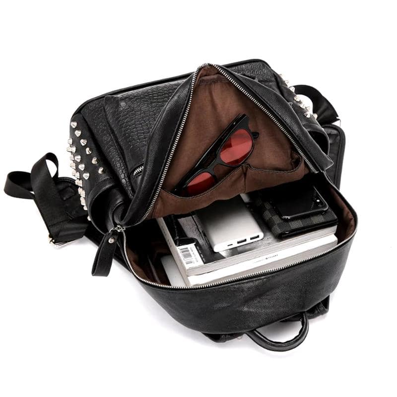 Fashion backpack with studded accents and organized interior, ideal for carrying essentials like sunglasses, gadgets, and personal items. Perfect for stylish and functional daily use.