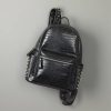 Black faux crocodile leather backpack with studded accents, trendy and fashionable for kids and teens. Perfect for school, travel, or casual outings, combining style and functionality.