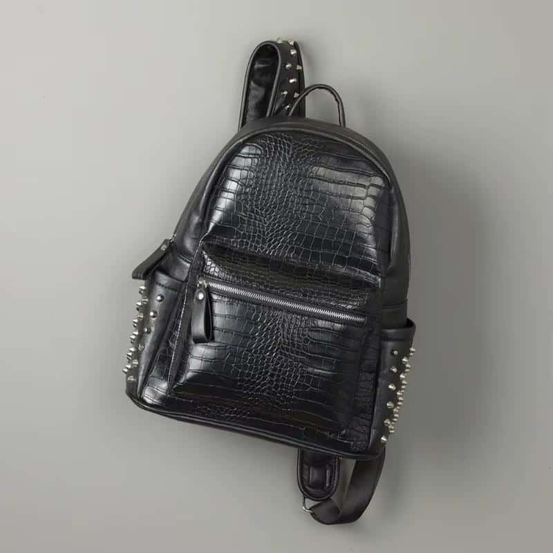 Black faux crocodile leather backpack with studded accents, trendy and fashionable for kids and teens. Perfect for school, travel, or casual outings, combining style and functionality.