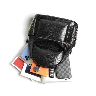 Luxurious black crocodile-pattern leather backpack with metal studs, perfect for stylish accessories and daily use.