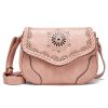 Stylish pink leather shoulder bag with intricate laser-cut floral design, braided handle, and adjustable strap, perfect for fashion-forward women seeking high-quality accessories.
