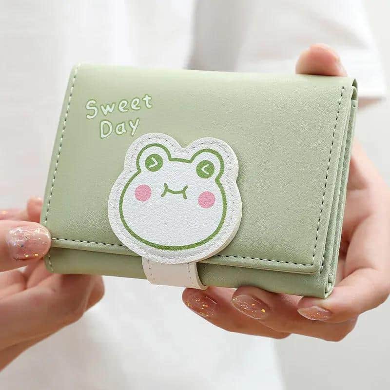 Cute frog patch on pastel green wallet with "Sweet Day" text, perfect for stylish accessories and gift ideas.