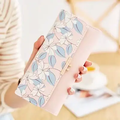 Soft pastel floral wallet with elegant branding and gold accents, perfect for stylish women’s accessories.
