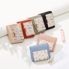Colorful women’s wallets with floral patterned cardholders on top of pastel notebooks.