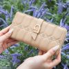 Elegant beige designer wallet with quilted floral details and gold accents, perfect for luxury fashion and accessories.