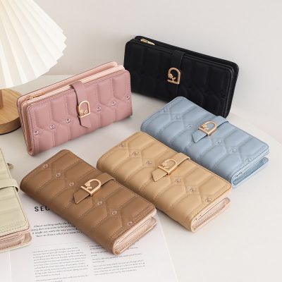 Pink quilted wallet with gold-tone clasp on Monalisa Store display.