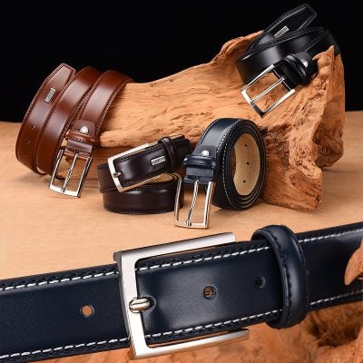 Black leather belt with silver buckle, neatly coiled on wooden display with other belts in various colors at Monalisa Store.