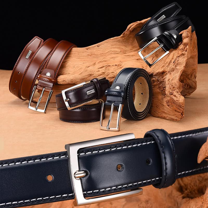 Black leather belt with silver buckle, neatly coiled on wooden display with other belts in various colors at Monalisa Store.