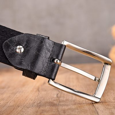 Vintage black leather belt with silver buckle for men's fashion, accessory, and casual wear. Durable leather strap with classic silver-tone buckle for a stylish look.
