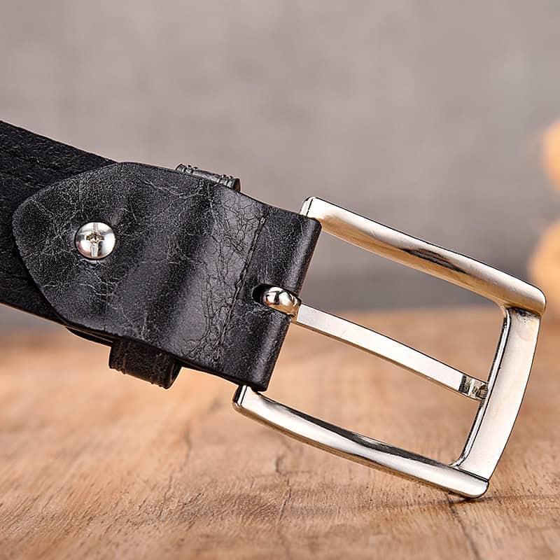 Vintage black leather belt with silver buckle for men's fashion, accessory, and casual wear. Durable leather strap with classic silver-tone buckle for a stylish look.