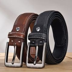 Brown and black leather belts with metal buckles on wooden surface - Monalisa Store, premium quality men's fashion accessories for style and durability.