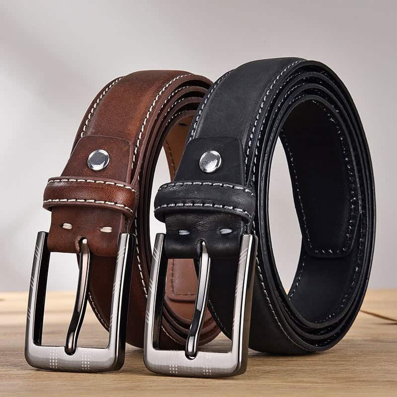 Brown and black leather belts with metal buckles on wooden surface - Monalisa Store, premium quality men's fashion accessories for style and durability.