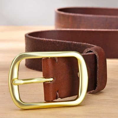 Leather belt with gold buckle on wooden surface, fashion accessory, vintage style, men's belt.