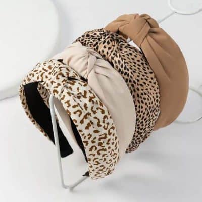 Leopard print wide headband with knot detail in neutral tones for women, stylish and comfortable accessory for everyday wear and special occasions.