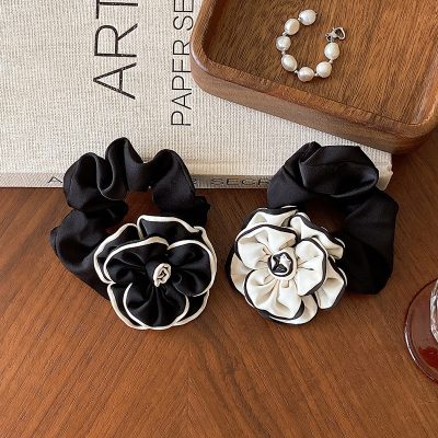 Black and white satin floral hair accessories set with scrunchies, perfect for elegant hairstyles and special occasions.