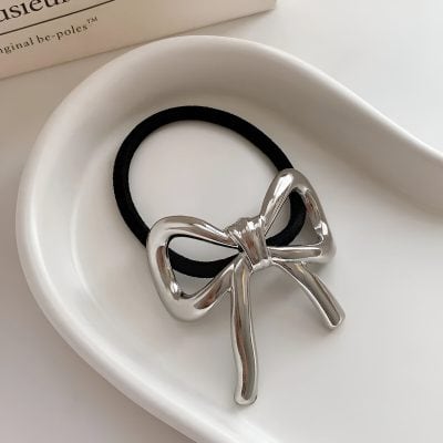 Elegant silver bow-shaped hair tie accessory with a sleek design, perfect for fashion-forward hairstyles and affordable hair accessories at Monalisa Store.