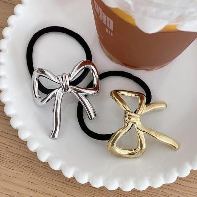 Elegantly designed metallic bow hair clips in silver and gold, perfect for adding a stylish touch to any hairstyle, ideal for fashion-conscious women and girls.