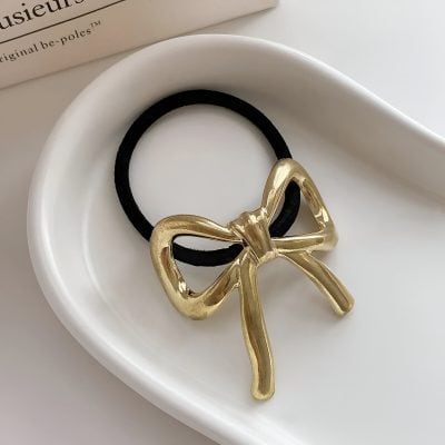 Gold bow hair tie on black elastic, elegant and stylish accessory, ideal for women, perfect for casual or formal wear, Monalisa Store jewelry and hair accessories.