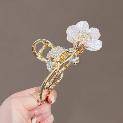 Gold floral hairpin with gemstone accents and pearl details for women’s accessories perfect for elegant occasions.