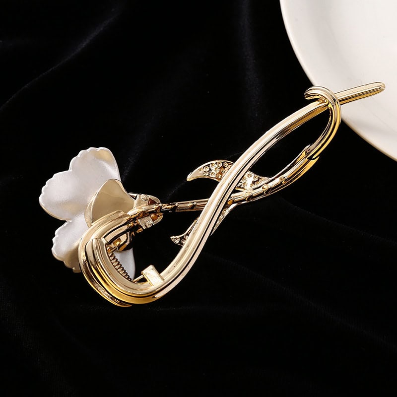 Crafted gold brooch with floral and leaf design, accented with sparkling gemstones, ideal for elegant accessories and fashion statements.