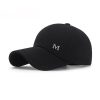 Black baseball cap with a gray "M" logo, stylish and comfortable for everyday wear, ideal for sports, casual outings, and sun protection, available at Monalisa Medical Store.