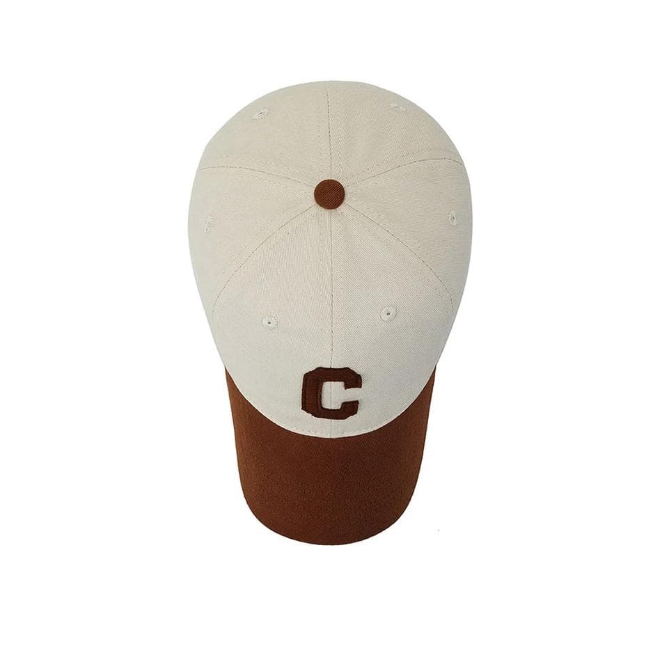 Baseball cap with embroidered letter "C" on front, two-tone beige and brown, stylish accessory for sports fans and casual wear.