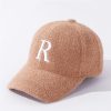 Soft peach-colored fleece baseball cap with white embroidered "R" logo, stylish and comfortable accessory ideal for casual wear and outdoor activities.