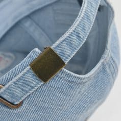 Denim handbag with gold hardware, close-up shot, stylish and trendy accessory for women.