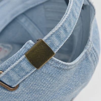 Denim handbag with gold hardware, close-up shot, stylish and trendy accessory for women.