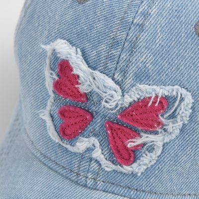 Butterfly embroidery on denim pocket, fashionable women's jeans with colorful stitched butterfly design.