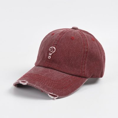 Question mark distressed baseball cap, red worn-out hat with torn edges, casual accessory for streetwear, unique design for fashion-forward individuals, perfect for everyday style and outdoor activities.