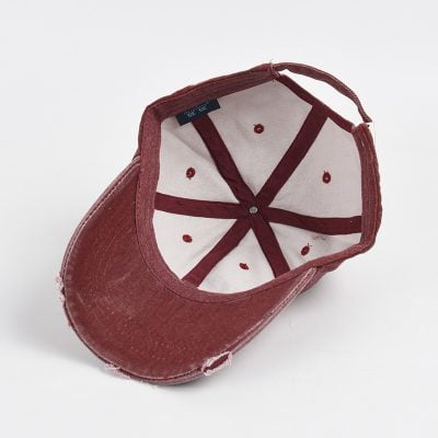Vintage red distressed baseball cap with adjustable strap, inside view showing interior stitching and lining, perfect for casual wear and sun protection.