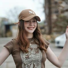 Stylish young woman wearing sunglasses and casual clothing outdoors, showcasing modern eye care accessories at Monalisa Medical Store.