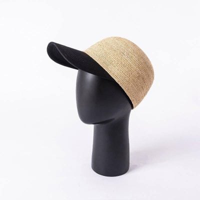 Stylish beige and black straw sun hat on a matte black mannequin head, perfect for outdoor sun protection and fashion.